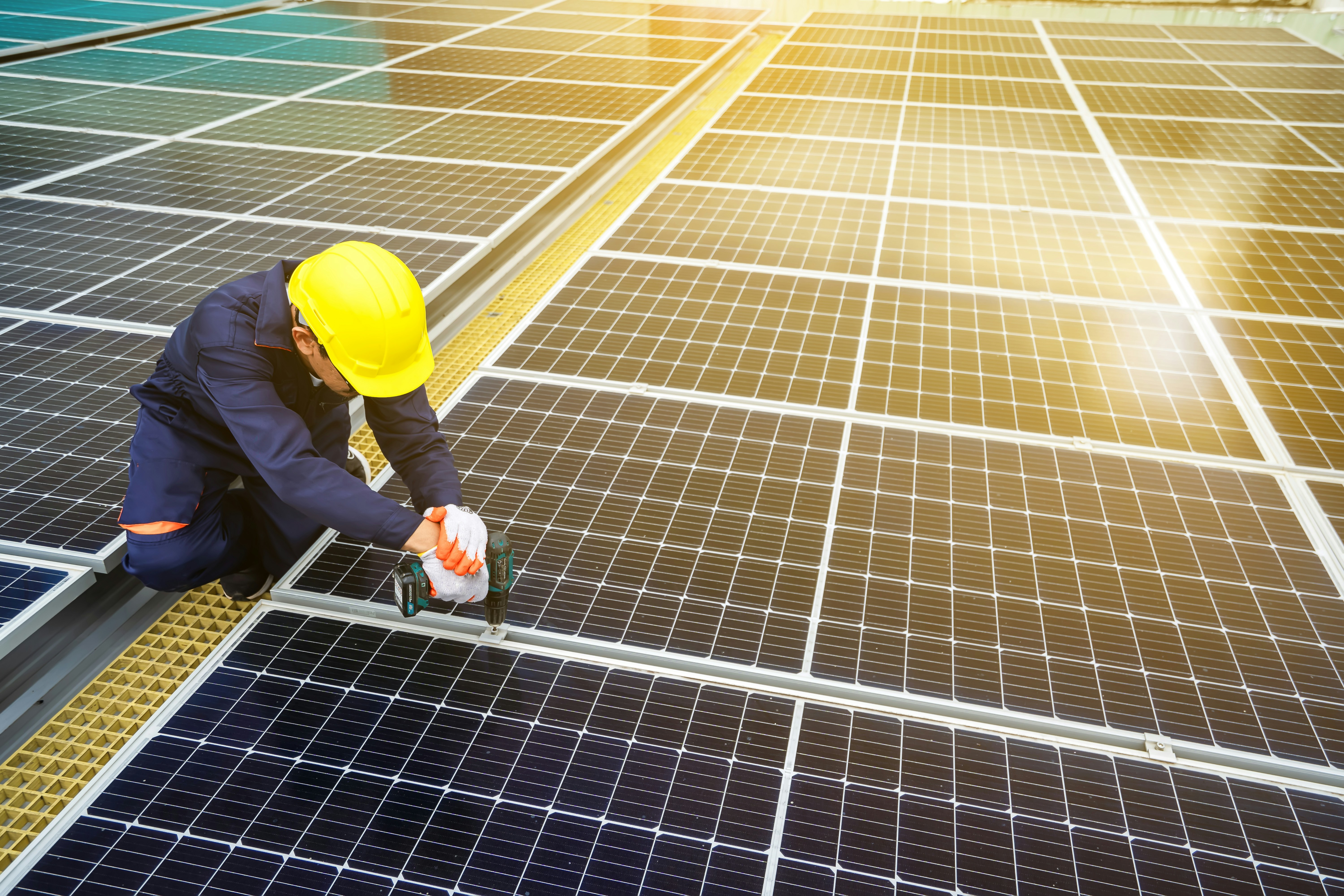 Solar panel installer working on a rooftop array